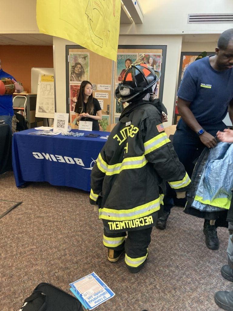 students tried on firefighting equipment